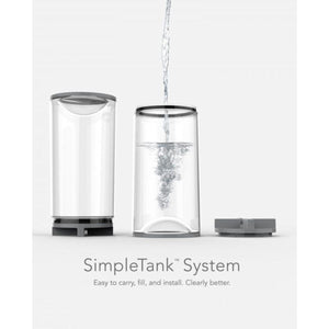 Clear evaporative humidifier tank by Vornado, shown disassembled with one section being filled with water.