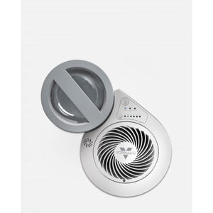 Silver evaporative humidifier by Vornado, seen from an overhead angle, partially open to show its fan grill and control panel.