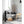 Black tower circulator by Vornado with a sleek, tall design and silver base, standing in a modern living room.