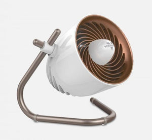 White personal air circulator by Vornado with a rose gold fan grill and bronze stand, angled upwards.