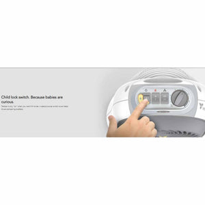 Small ice white nursery heater by Vornado, with a child's hand pressing a yellow child lock button on its control panel.