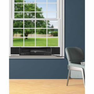 Black Transom window air circulator by Vornado, installed in a white window frame with a digital display.