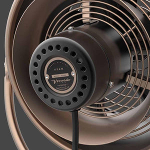 Gunmetal VFAN fan by Vornado, with a bronze grill and 'Vortex Air Flow' and 'VFAN' on the back plate.