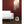White oval whole room heater by Vornado with a spiral grill, on a wooden floor beside a white sofa.