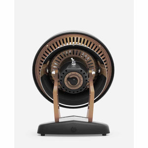 Vintage room heater by Vornado, black with copper grille and stand, back view showing controls.