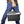 Dark gray and white Thermo-Electric Cooler/Warmer by Wagan with a black strap, carried by a person in blue jeans.