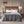 Grey ribbed plush to Berber heated blanket by Woolrich, draped over a bed with white pillows in a rustic bedroom.