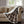 Brown plaid heated throw by Woolrich with white sherpa lining draped over a beige couch.